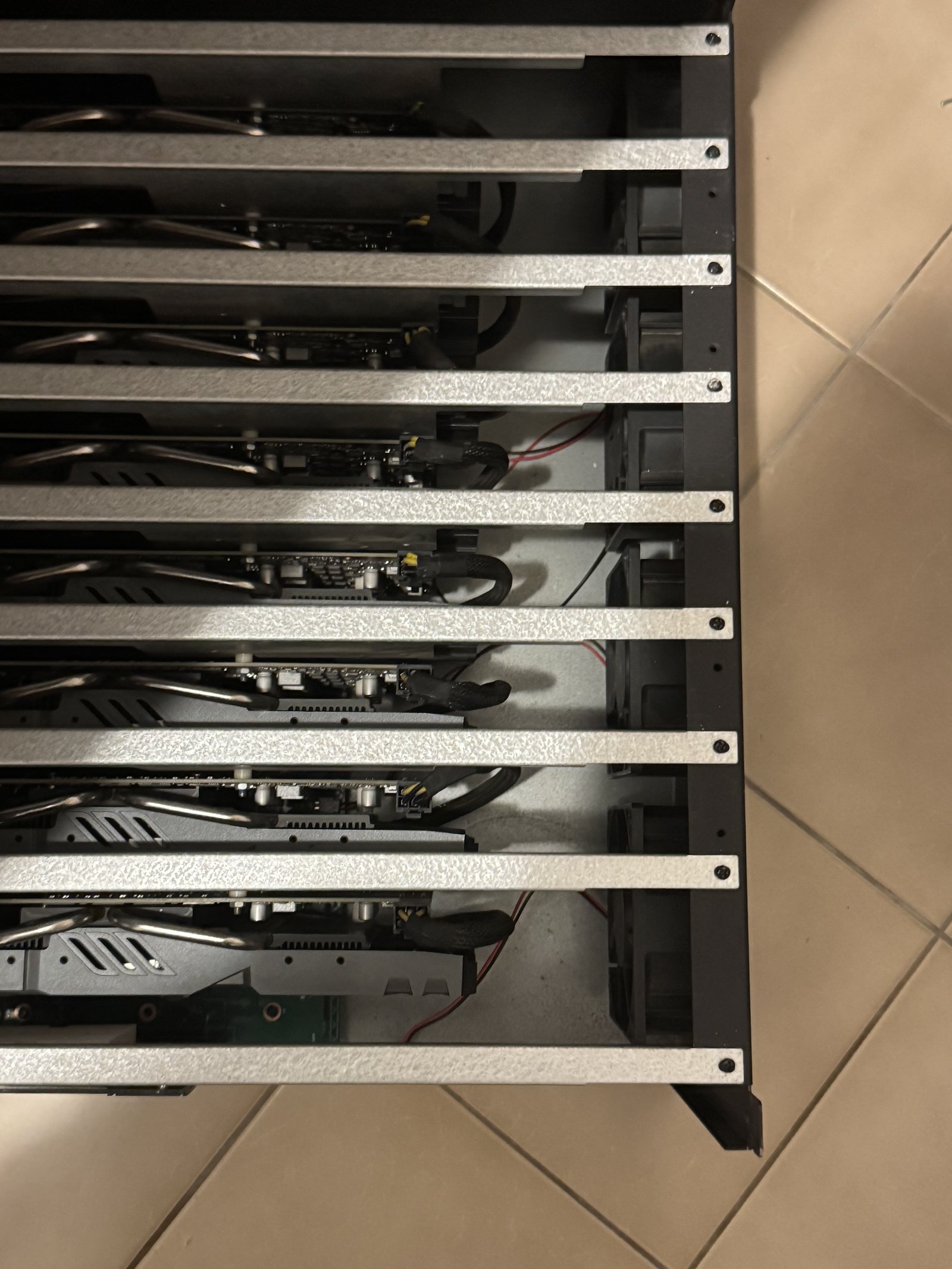 Top view of eight graphics cards mounted in an open metal frame, used as a local AI server